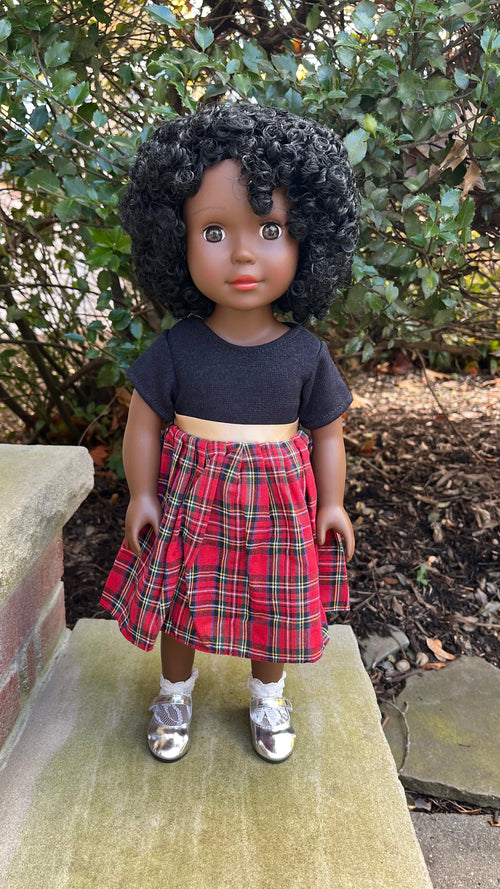 A Dark Brown Skin Tone Doll in a Black & Red Holiday Dress